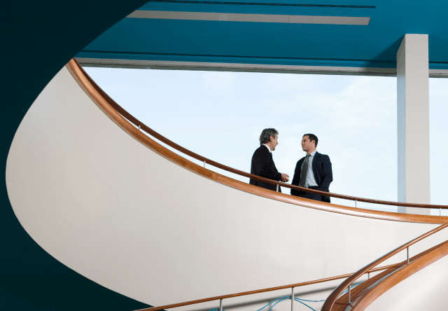 Two advisors having a conversation near a stairs