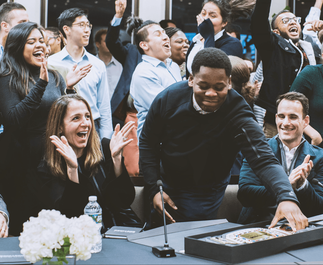 Group of students clapping a fellow student who won an award