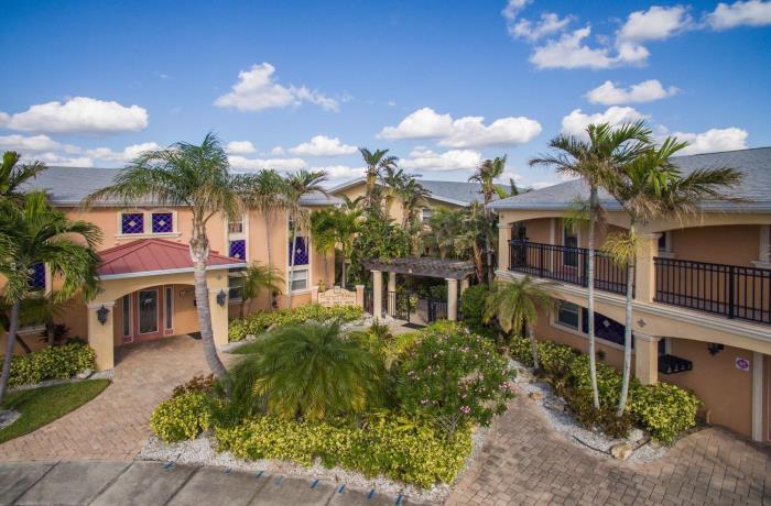 Aerial view of villas with balcony and palm trees